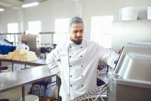 istock A baker makes the dough on the equipment in the bakery 1185497651