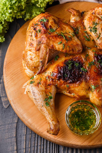 istock Roasted chiken on wooden board with sauce 1185497985