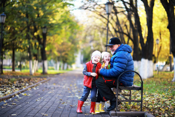 istock Children walk in the autumn park 1185498289