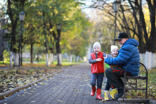 istock Children walk in the autumn park 1185499308