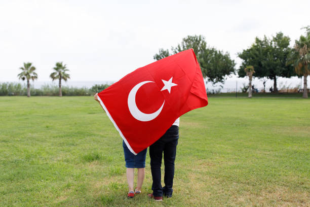 istock Young Turkish Couple And The Turkish Flag 1185499493