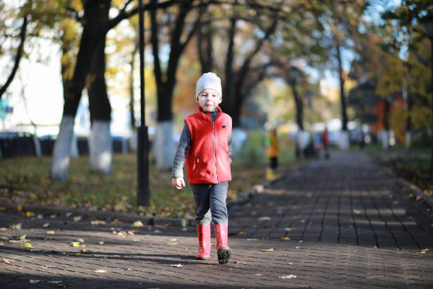 istock Children walk in the autumn park 1185499662