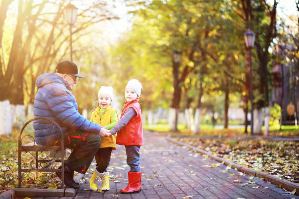 istock Children walk in the autumn park 1185500370