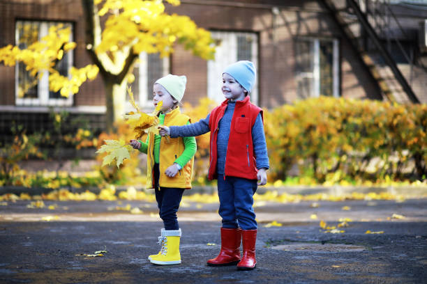 istock Children walk in the autumn park 1185500449