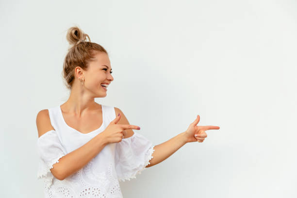 istock Attractive girl pointing fingers on empty copy space 1185500829