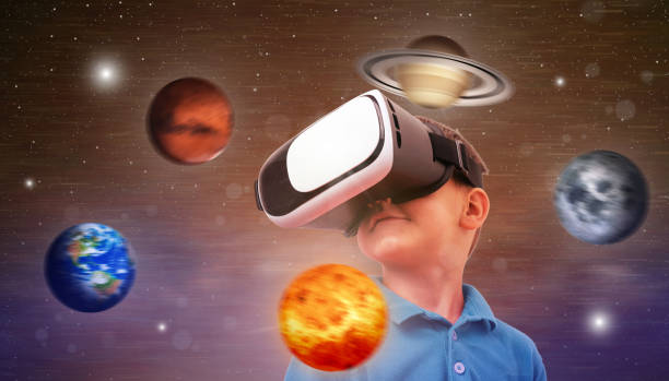 istock Boy uses a virtual reality headset to study the planets and the universe. Conceptual photo with a boy and planets revolving around his axis. 1185502068