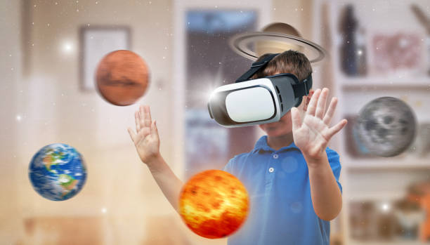 istock Boy with a virtual reality headset exploring planets in his room. The concept of using modern technologies for education. 1185502076