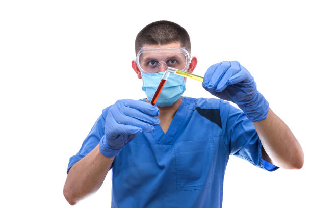 istock Lab assistant look color liquid in test tube 1185502805