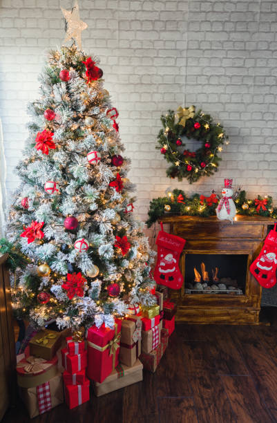 istock Decorated Christmas Tree Near Fireplace at Home 1185504862