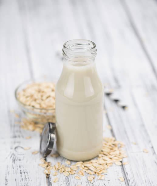 istock Old wooden table with fresh Oat Milk (close-up shot; selective focus) 1185506800