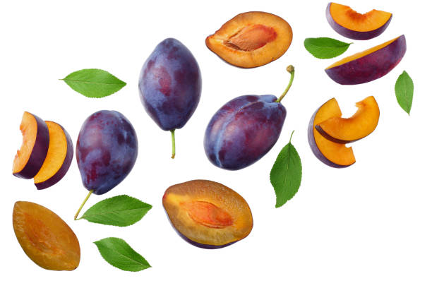 istock fresh plum fruit with green leaf and cut plum slices isolated on white background. top view 1185506949