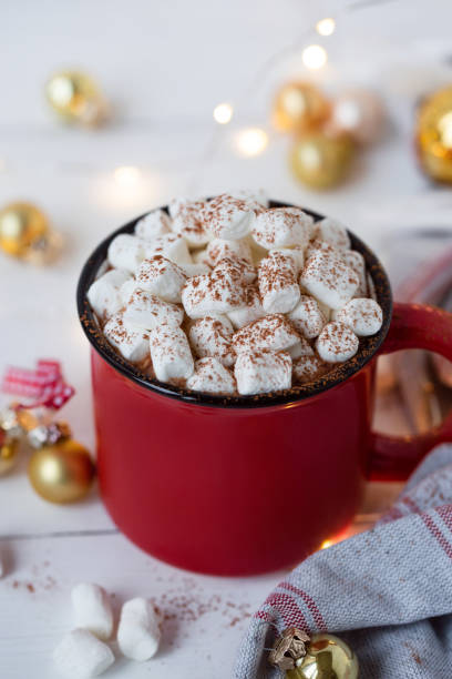 istock Hot chocolate in red cup with marshmallow on white christmas background. 1185509774