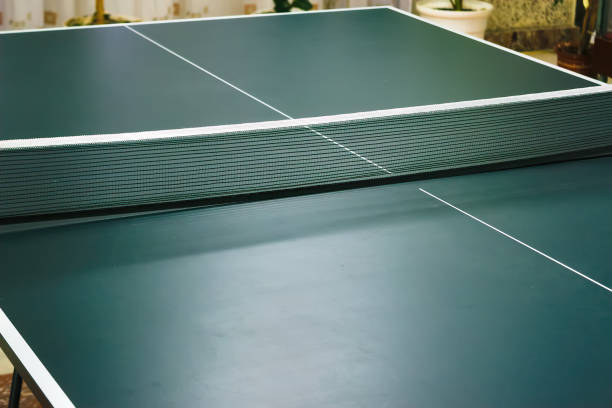 istock Ping pong table with net close-up. Green ping pong table close-up. 1185510673