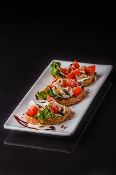 istock Bruschetta with tomatoes, lettuce, camambert, balsamic vinegar 1185511151
