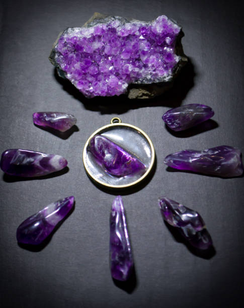 istock Top view on purple amethysts, necklace and amethyst geode on dark background 1185514946