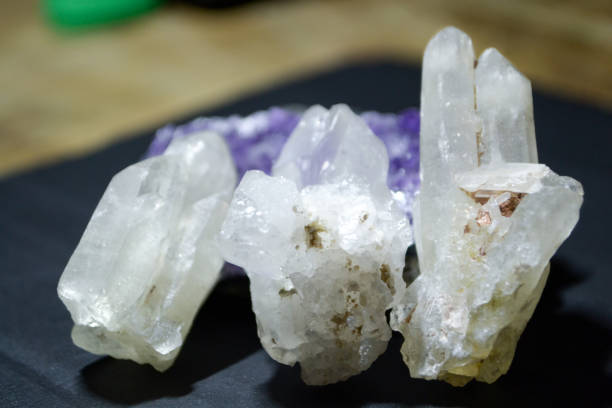 istock Three white rocks crystal quartz on dark background 1185514952