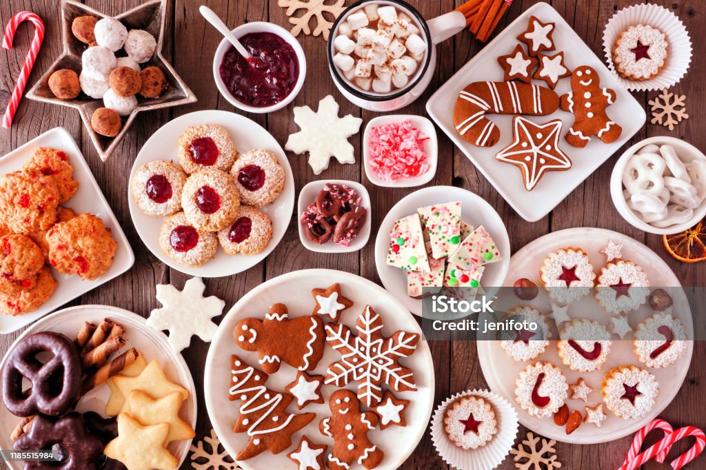 Christmas baking table scene with assorted sweets and cookies, top view over a rustic wood background Christmas table scene of assorted sweets and cookies. Top view over a rustic wood background. Holiday baking concept. Christmas Stock Photo