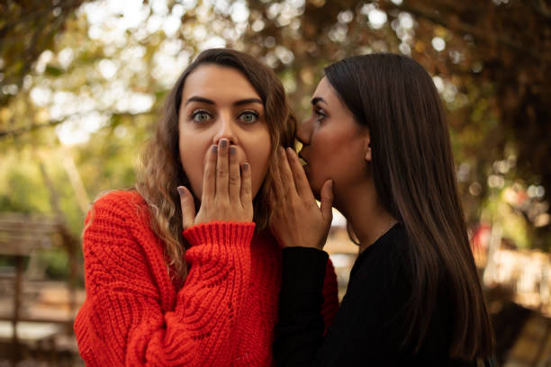 istock ear to ear, says something to your girlfriend's ear 1185520813