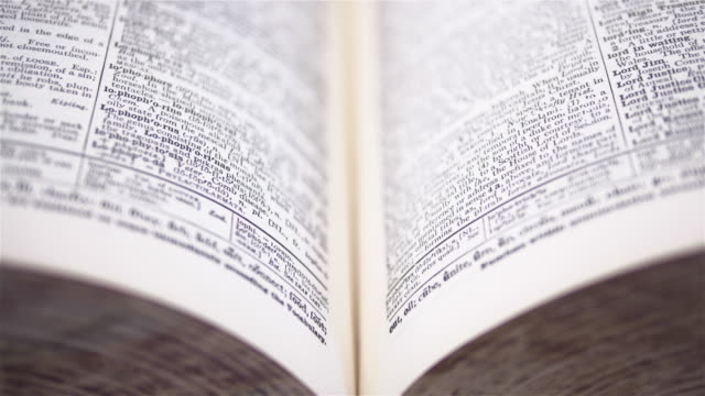 4K - Camera moves above the dictionary. Close-up