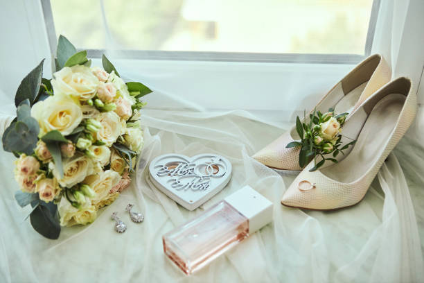 istock bridal accessories such as shoes, bouquet , ring and perfume lie on a table 1185521861