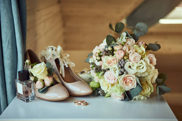 istock bridal accessories such as shoes, bouquet , ring and perfume lie on a table 1185521889