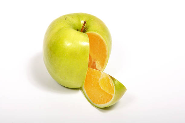 istock Green apple outside an orange inside, isolated on white background 118552340