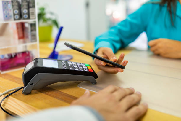 istock Woman making a contactless payment at the pharmacy 1185526621