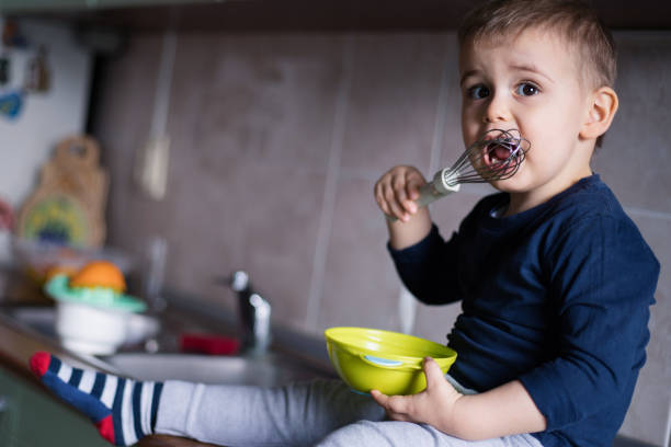 Closeup of child eating sweet food at home