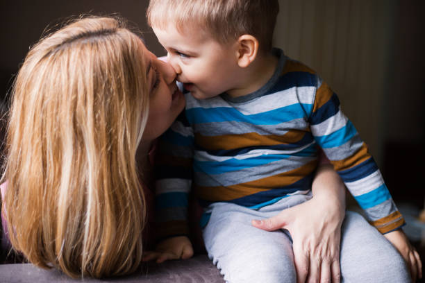 istock Cute young boy cuddling with his mom 1185532476