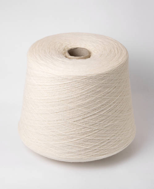 istock bobbin of yarn on a white background. Side view.Textile reel on isolated white background. 1185534328