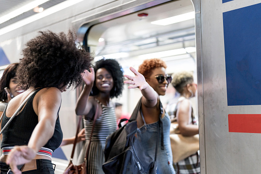 Group of women waving goodbye to friends