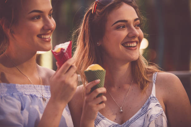 istock Two young women eating ice cream 1185536580
