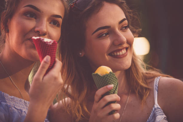 istock Two young women eating ice cream 1185536584