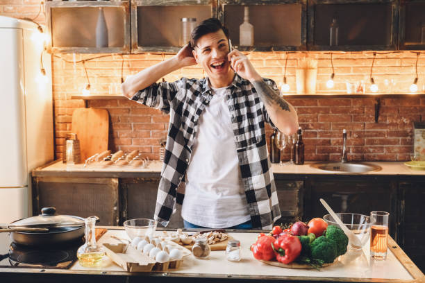 istock Hello! Party? Happiness man call his friends at kitchen 1185536586