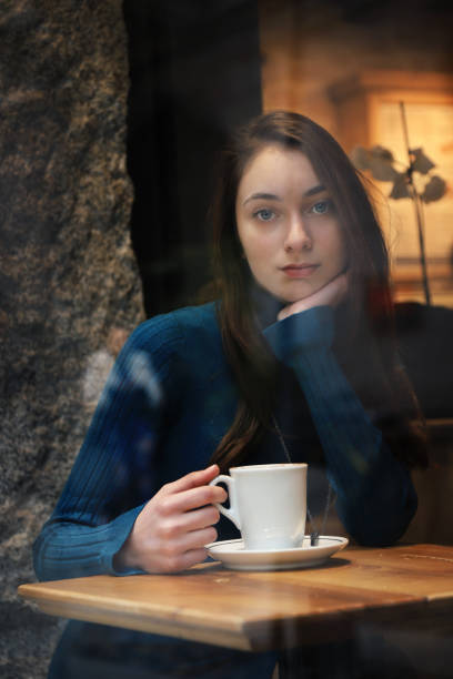 istock Young woman drinking coffee 1185536590