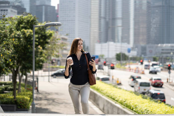 istock Woman going to workplace, holding coffee cup 1185536712