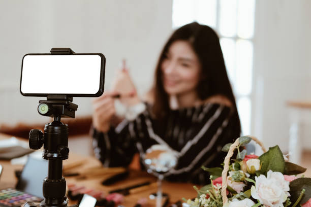 istock beauty blogger live broadcasting cosmetic makeup tutorial on social media. 1185537154