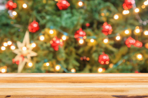 istock Empty wood table top with Abstract blur Christmas tree with decoration bokeh light background for product display 1185539352