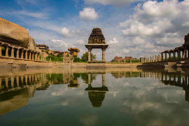 Hampi, Karnataka, India - September 25, 2010: Ruins of Hampi, ancient capital of Vijayanagar and beautiful lake surroundinga temple