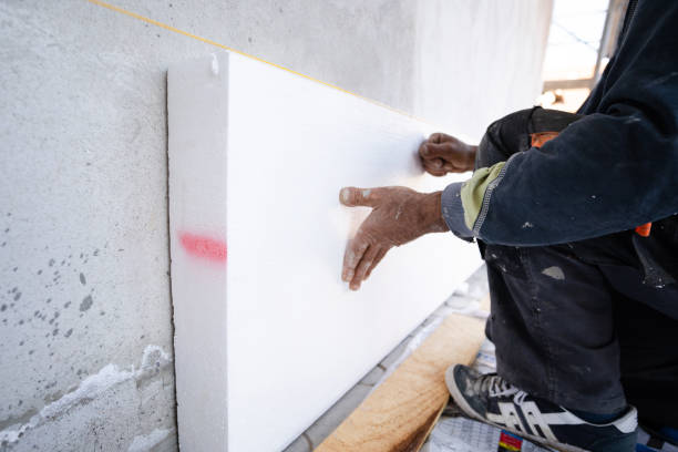 istock Worker placing styrofoam sheet insulation to the wall at construction site Rigid extruded polystyrene insulation board for energy saving Of Facade house renovation energy efficient 1185544091