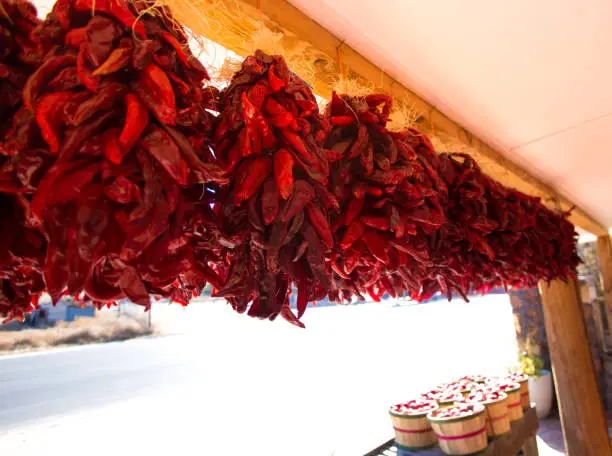 Española, NM: Outdoor Stand Selling Chili Pepper Ristras, Apples. Copy space available.
