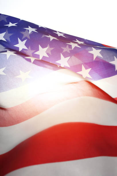 istock American Flag Backlit of Sunlight 1185544410