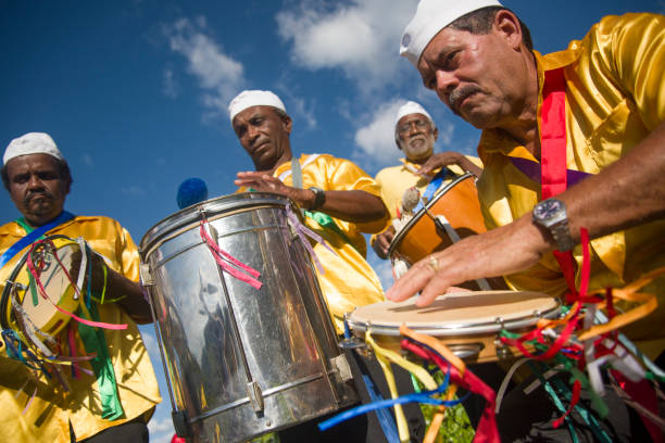 Gonçalves, Minas Gerais, Brazil - March 19, 2016: Brazilian men in costume playing drums, celebrating the Revelry of Kings during carnival in the countryside of Gonçalves city