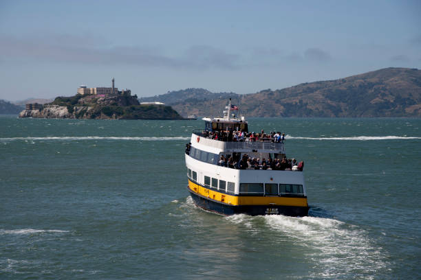 San Francisco city San Francisco, June 03, 2019 - A tourist boat taking tourist to Alcatraz Island in San Francisco Bay fishermans wharf san francisco photos stock pictures, royalty-free photos & images