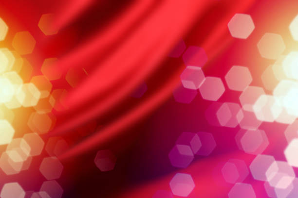 istock Red Silk Curtain with Defocused Lights Background 1185553170