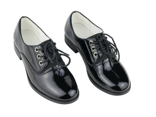 istock Two beautiful black women's leather shoes isolated on white background. 1185554149
