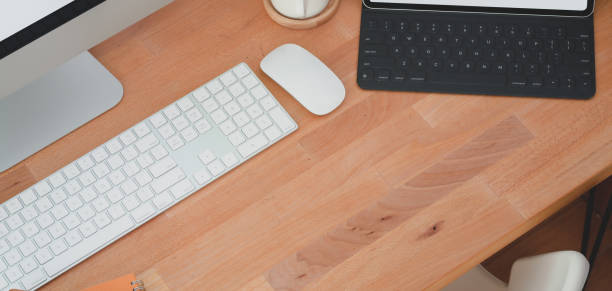 istock Cropped shot of comfortable workplace with keyboard computer and desktop computer with other office supplies 1185561272