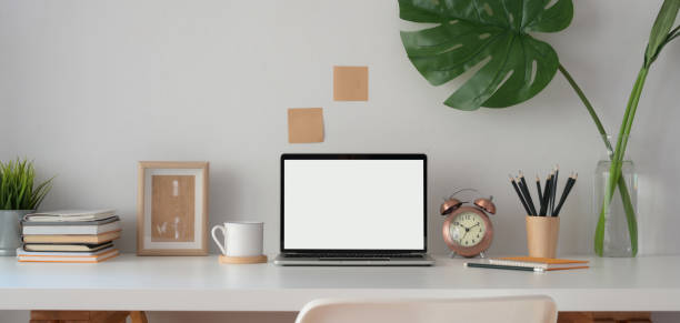 istock Modern office room with blank screen laptop computer with office supplies and decorations 1185561882