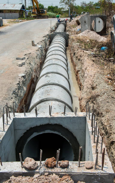 istock Concrete Drainage Pipe row on a Construction Site .Concrete pipe stacked sewage water system aligned on site. 1185562214