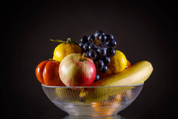 istock A vase of fresh wet fruit over black 1185564903